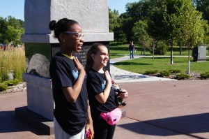 Zipporah and Natty finishing a challenge. At this point, Gnomio, being held by Natty, still has his conical hat.